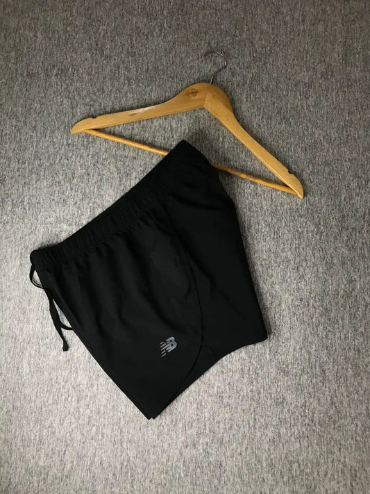 Enhance your sportswear collection with these preloved New Balance Black Sports Shorts. These shorts are perfect for any athletic activity or casual outing, offering great comfort and style. They are in excellent condition and ready for a new home. Product Details: •	Brand: New Balance •	Color: Black •	Size: L •	Condition: Preloved, 9/10 Condition •	Material: Performance Fabric •	Care Instructions: Machine wash cold, tumble dry low